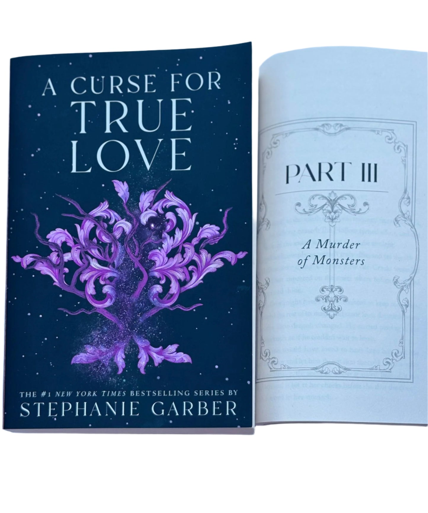 Book titled 'A Curse for True Love' by Stephanie Garber with a purple tree design on the cover.